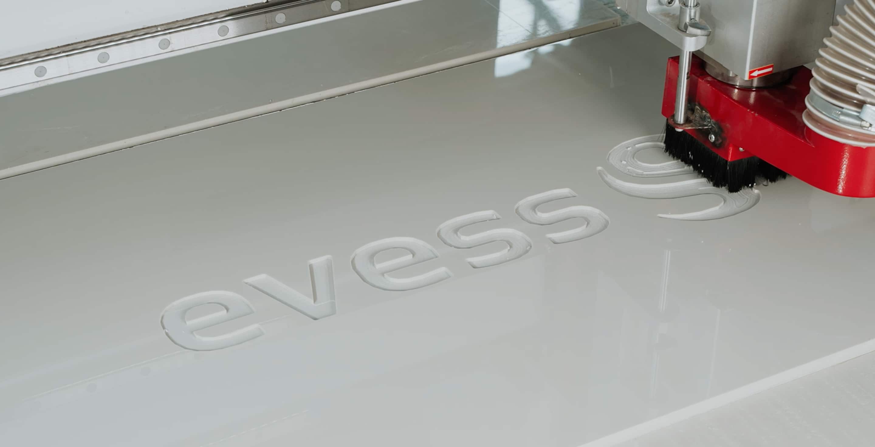 Machining a part engraved with the EVESS logo on a CNC machine